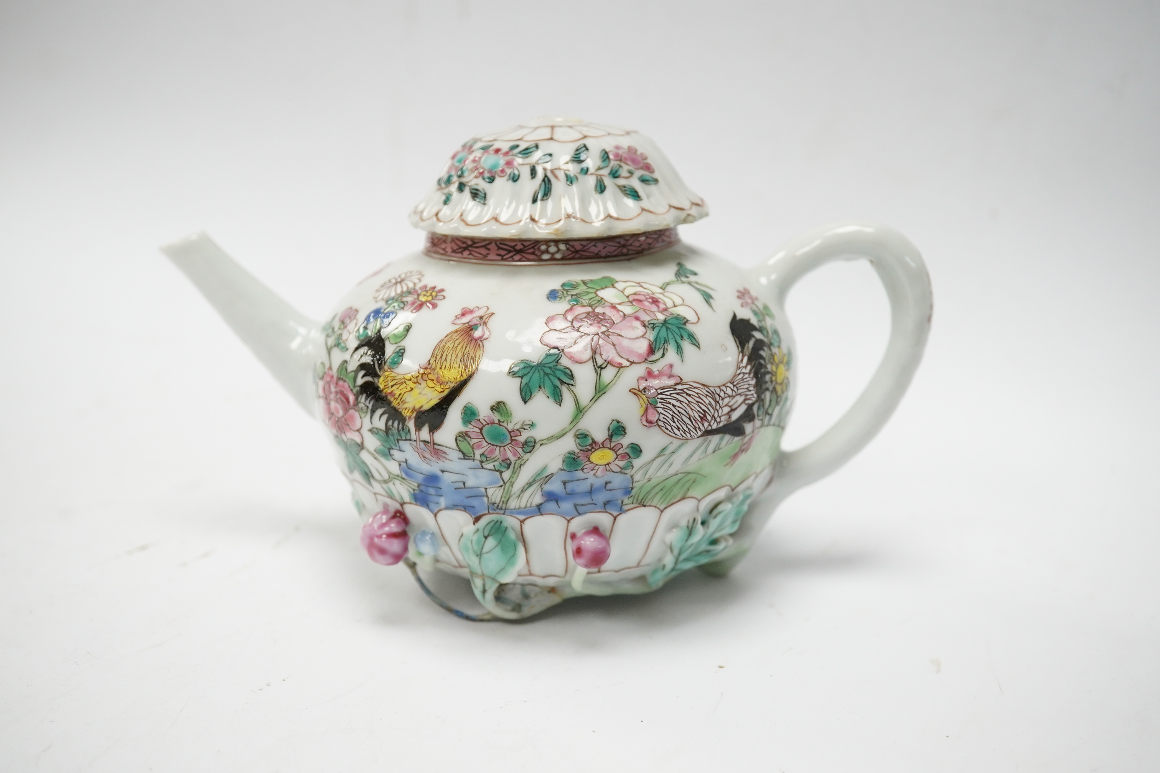 A Chinese famille rose chrysanthemum moulded teapot, early Qianlong period, painted with a cockerel amongst flowers, on a cage work base, 10cm high. Condition - restored